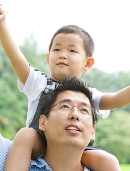 A father playing with his child on a nice summer day.