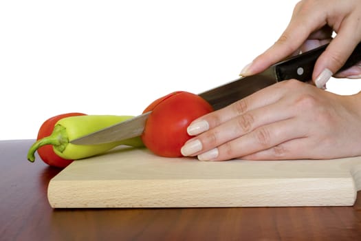 Cutting tomato on wooden board