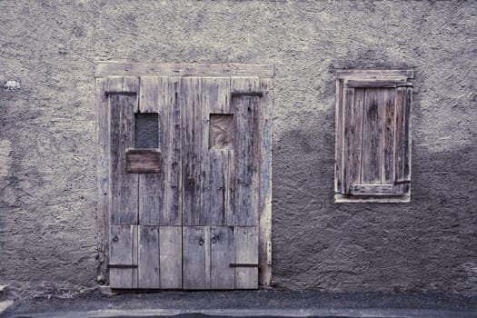 Vintage door and window in Croatian village house. Image cross processed to reflect age.