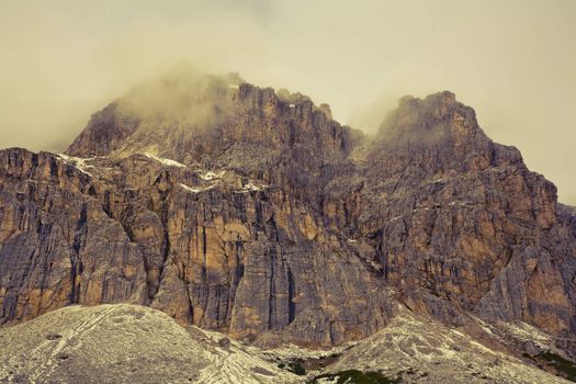 September morning with low hanging clouds in the Dolomites. Image is cross processed and a little film grain added to reflect age.