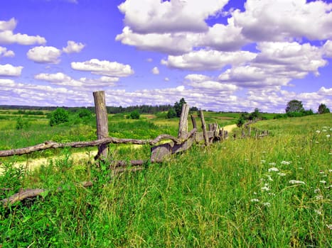 old fence on field near roads