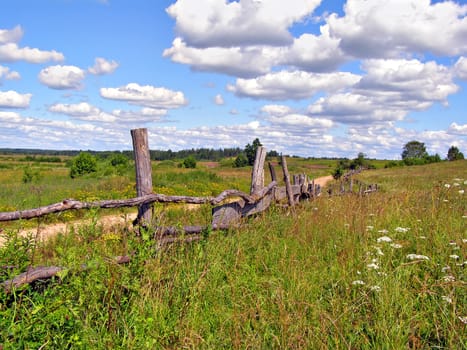 old fence on field near roads