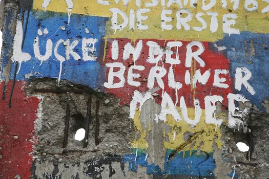 Graffiti and greetings on one of the remaining sections of the old cold war Berlin wall - Germany. The German text says:" The first holes in the Berlin Wall."