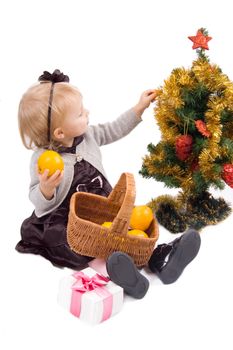 Little girl with Christmas tree and gifts over white