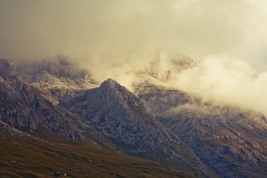 September morning with low hanging clouds in the Dolomites. Image is cross processed and a little film grain added to reflect age.