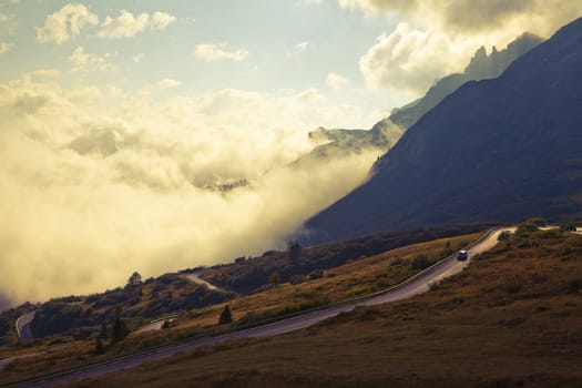 Early September morning in the Dolemites, Italy with low hanging clouds. Image is cross processed to reflect age.