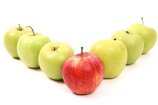 apples arranged on a white background to symbolize teamwork, leadership, discrimination............