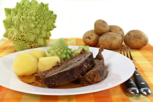 Roast beef with potatoes and Romanesco