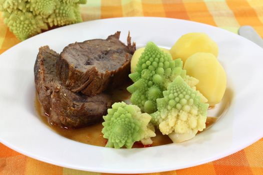 Roast beef with potatoes and Romanesco