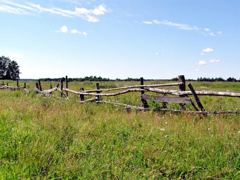 old fence on autumn field