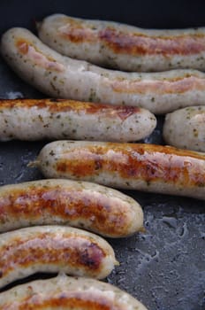 a sausage grilled on a camp fire