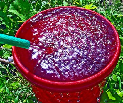 streem of water in red pail