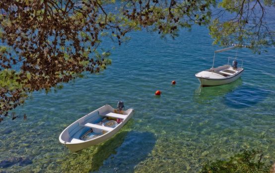 To dinghys in the crystal clear Adriatic Sea - Croatia at summertime.