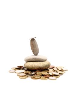 Coins and Pepples on white background as a symbol for financial balance