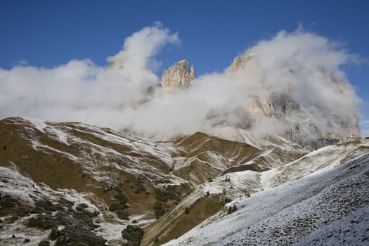 September morning with low hanging clouds and the first snow in Passo di Sella, Italy.