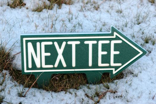 the next tee sign on an irish golf course in the winters snow