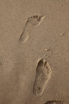 Human trace of a foot on yellow sand