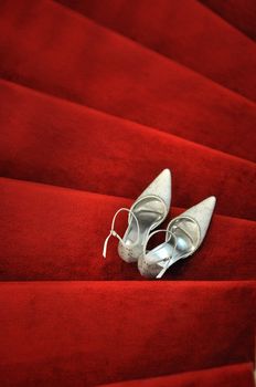 White bridal shoes on red carpet