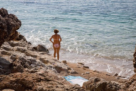 Mature female in bikini by the Adriatic Sea - Dubrovnik, Croatia.