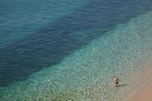 two female bathing in the Adriatic Sea on the beach of Dubrovnik - Croatia.