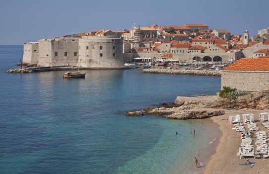 The old Croatian town Dubrovnik by the Adriatic Sea seen with the beach in front.