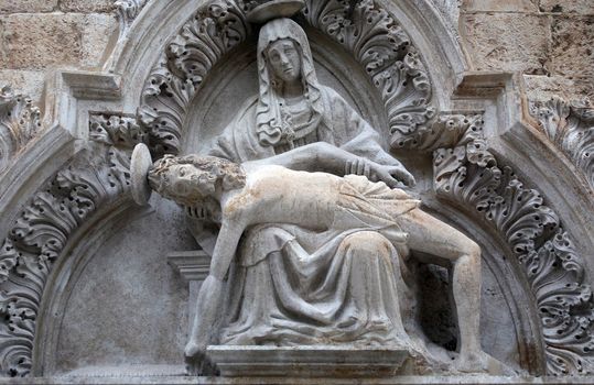 Statue of Our Lady of Sorrow on the portal of the Franciscan church of the Friars Minor in Dubrovnik