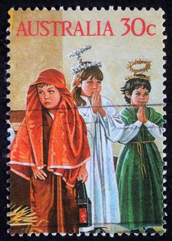 AUSTRALIA - CIRCA 2004: A greeting Christmas stamp printed in Australia shows children play to the Holy Family