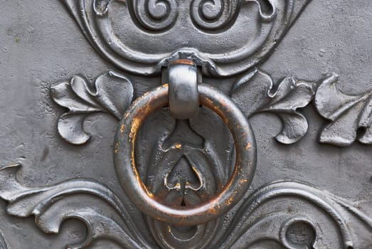 Closeup of metal vintage door with metal door handle, old medival style taken in Moscow, Russia
