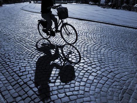  A warm spring afternoon a young girl is biking through the old streets of Copenhagen, Denmark.                      