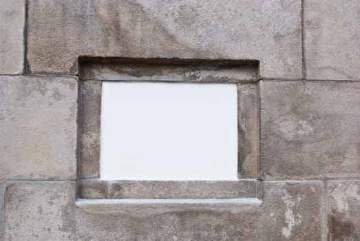 White board on the center of aged stone wall
