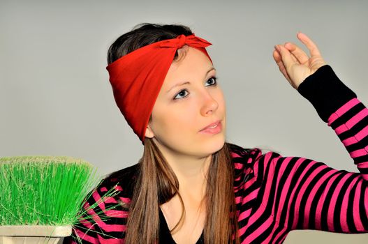 Girl with a red handkerchief on his head preparing to clean the apartment