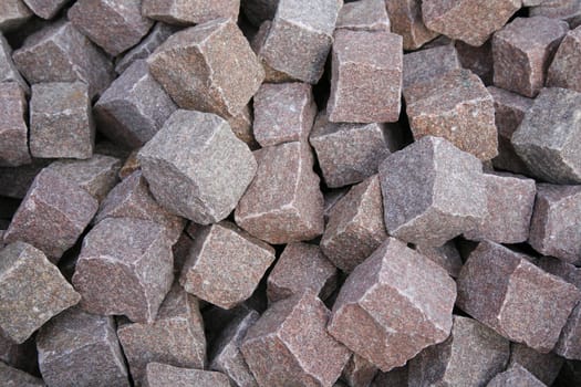 Pile of red granite cobble stone