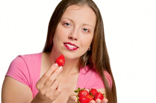 Beautiful girl stretches strawberries which is in her hand