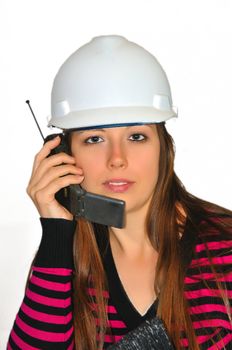 A girl in a white construction helmet, said by mobile phone with a customer