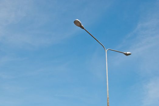 Street light pole on a sunny day and clear summer sky
