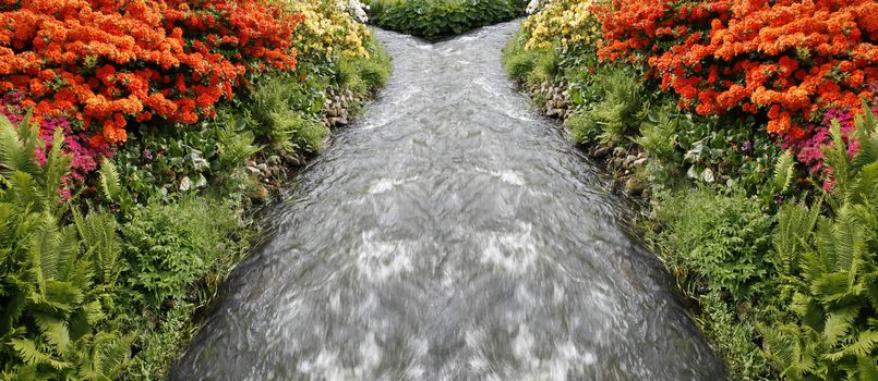 Fantasy stream with nice colorful Azealeas in beautiful Danish park.