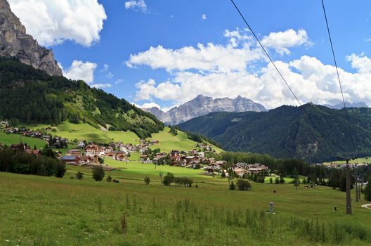 summer view of Colfosco village and Badia valley. Italy
