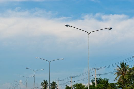 Street light pole on a sunny day and clear summer sky
