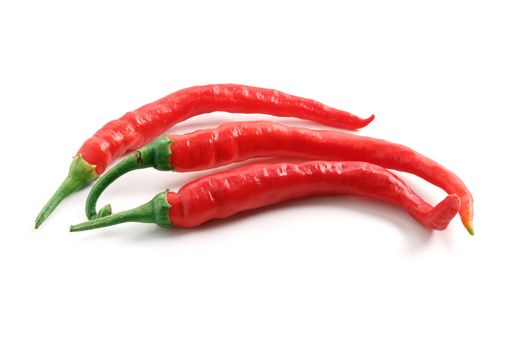 three hot chili peppers over white background