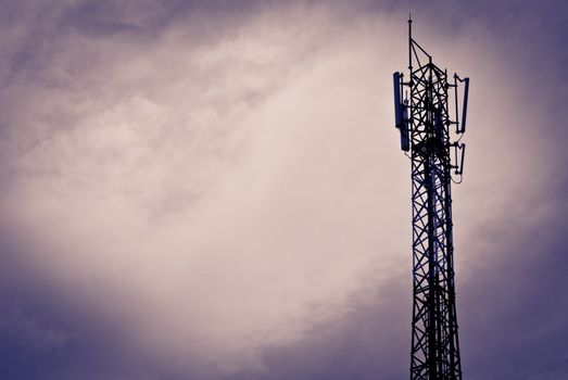 Mobile communication antenna taken on a cloudy day with silhouette
