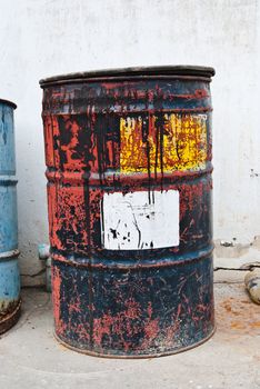 Old rusty oil drum with white sticker
