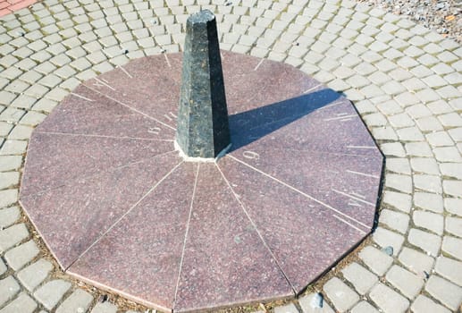 The sundial on granite base in the park
