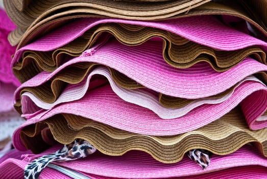 Stacks of colorful summer hats
