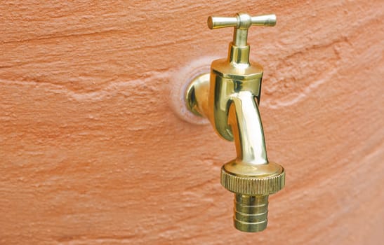 Old brass  Water Tap Against A  Wall 