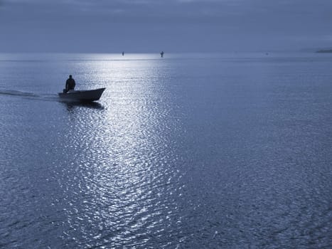 Boat returning in the moonlight. Duotone.