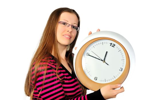 A young girl holding a wall clock against a gray background