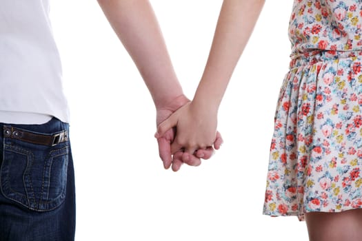 Closeup of young affectionate couple holding hands over white background.
