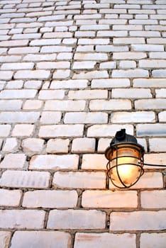 aging lamp on brick wall