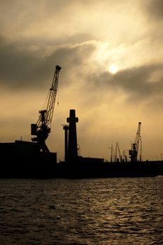 Skyline silhouette of Hamburg harbor, Germany, Europe, against dramatic sky.