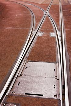 Public Transportation: Tramway switch and tracks integrated in pavement of city street.